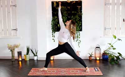 Photo of woman doing yoga in her home.