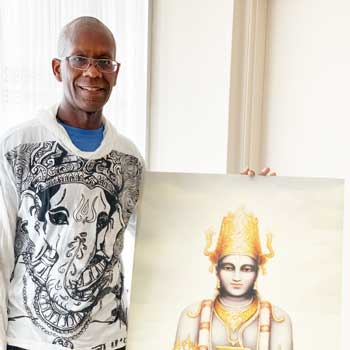 Barry next to an image of Lord Dhanvantari.